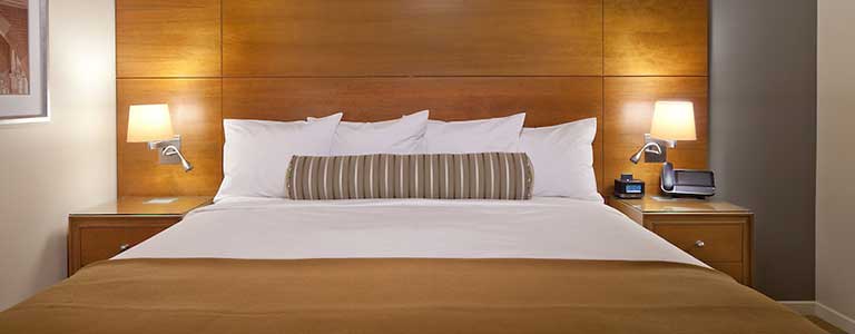 king bed in hotel room at ucla luskin conference center